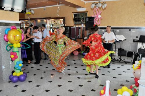 a group of people dancing in a room with balloons at Complex Domneasca in Seimeni
