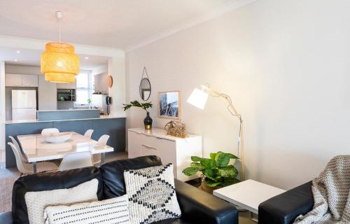 a living room with a couch and a table at Pacific Marina Apartments in Coffs Harbour