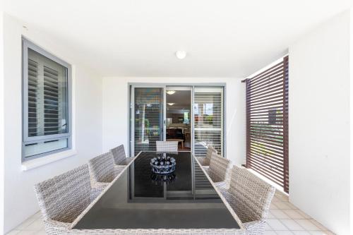 a dining room with a table and chairs at Pacific Marina Apartments in Coffs Harbour