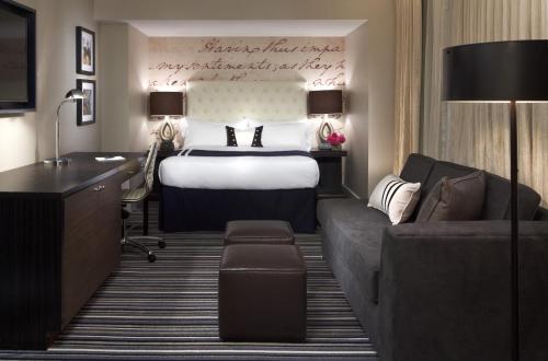 a hotel room with a bed and a couch at Kimpton George Hotel by IHG in Washington, D.C.