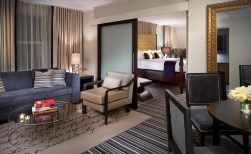 a living room with a couch and a room with a bed at Kimpton George Hotel, an IHG Hotel in Washington, D.C.