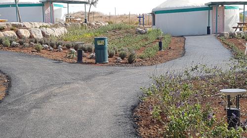 a garden with cacti and a path leading to a building at Village on the Cliff in Giv'at Yo'av