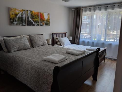 a bedroom with a large bed with two pillows on it at 2314 Rue Duff Court in Montreal