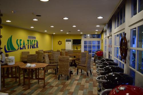 a dining room with tables and chairs in a restaurant at Sea Tiger Island Inn Shodoshima in Shodoshima