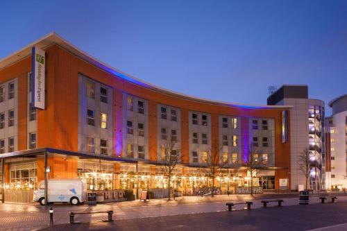 a building with a van parked in front of it at Holiday Inn Express Portsmouth Gunwharf Quays by IHG in Portsmouth