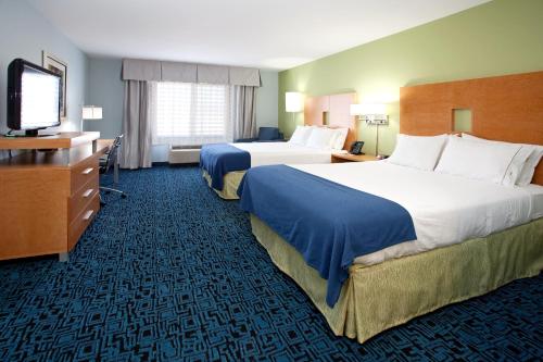 a hotel room with two beds and a flat screen tv at Holiday Inn Express Hotel & Suites Rock Springs Green River, an IHG Hotel in Rock Springs