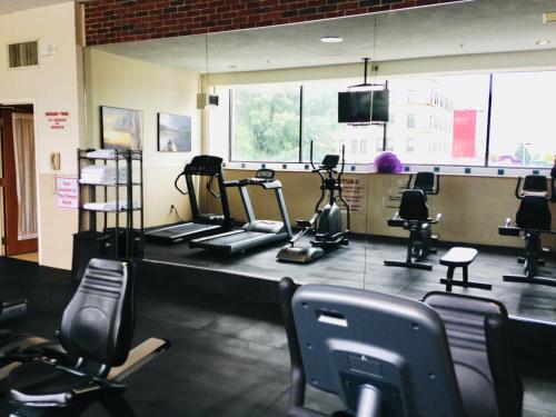 a gym with several treadmills and exercise bikes at Holiday Inn & Suites Pittsfield-Berkshires by IHG in Pittsfield