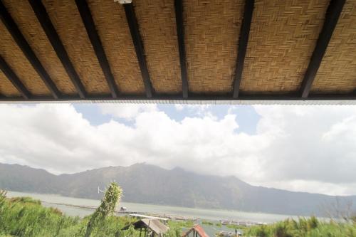 a view of a river with mountains in the background at Volcano Living in Kintamani