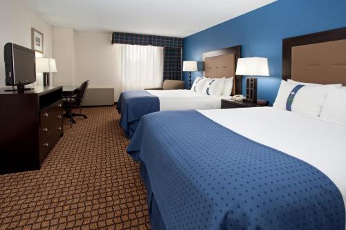 Een bed of bedden in een kamer bij Ramada Plaza by Wyndham Sheridan Hotel & Convention Center
