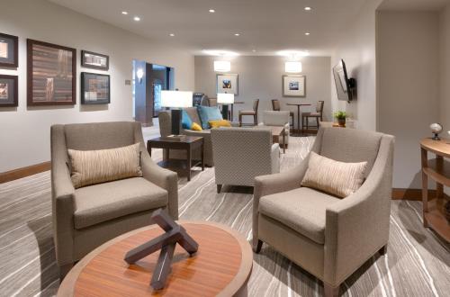 a waiting room with several chairs and a table at Staybridge Suites - Lehi - Traverse Ridge Center by IHG in Lehi