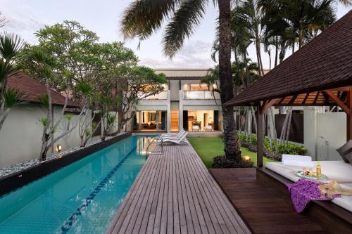 an exterior view of a villa with a swimming pool at Downtown Villas in Seminyak
