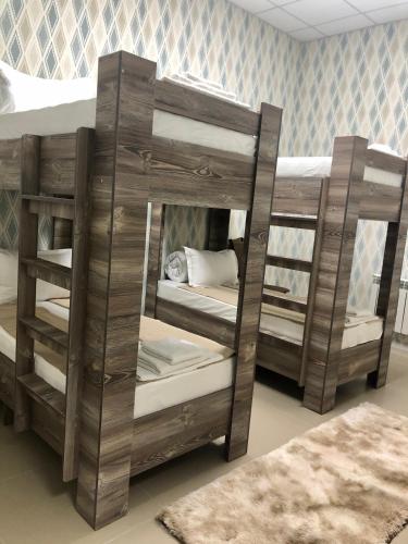 two sets of bunk beds in a room at Tarlan Hotel in Aktau