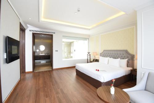 a hotel room with a bed and a table at Phu Cuong Hotel Ca Mau in Cà Mau