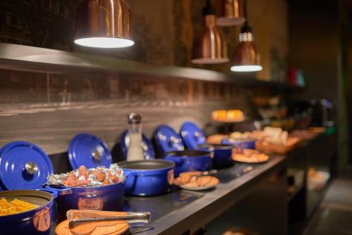 a buffet line with blue bowls and plates of food at CityNote Hotel Shangxiajiu Pedestrian Guangzhou in Guangzhou
