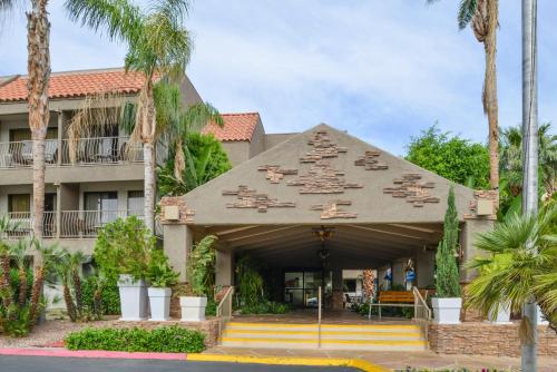 a building with palm trees in front of it at Holiday Inn Express Palm Desert by IHG in Palm Desert