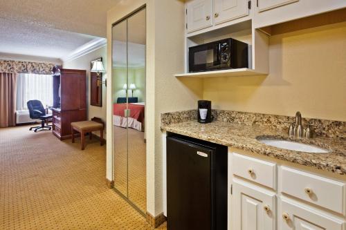 a kitchen with a sink and a room at Holiday Inn Express Ringgold - Chattanooga Area by IHG in Ringgold