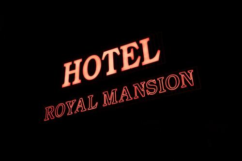 a neon sign that says hotel royal marsden at Royal Mansion in Kulu