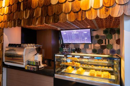 a bakery with a display case of food at Sky Gem Central Hotel in Ho Chi Minh City