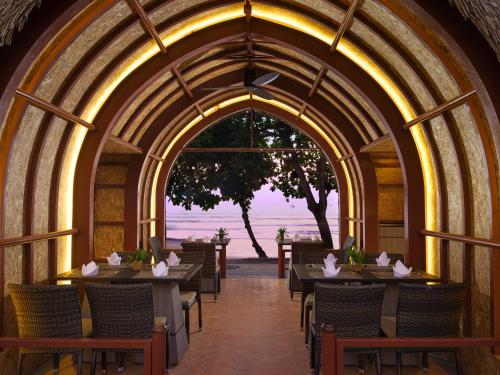 an archway with tables and chairs in a restaurant at Aonang Villa Resort I Beach Front in Ao Nang Beach