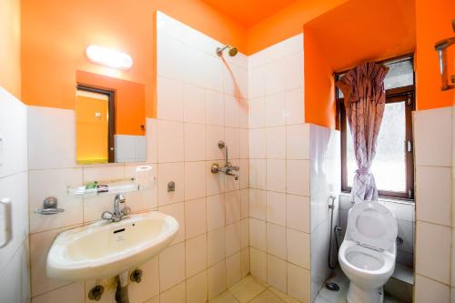 a bathroom with a toilet and a sink at Hotel Pomelo House in Kathmandu