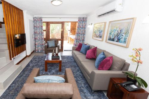 a living room with a couch and a table at Kruger Park Lodge Unit No. 610B in Hazyview