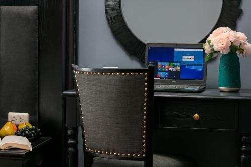 a desk with a laptop computer on top of a chair at Vientiane Boutique Hotel in Vientiane