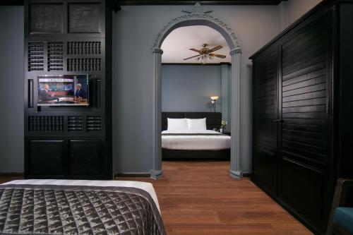 a bedroom with a bed and a ceiling fan at Vientiane Boutique Hotel in Vientiane