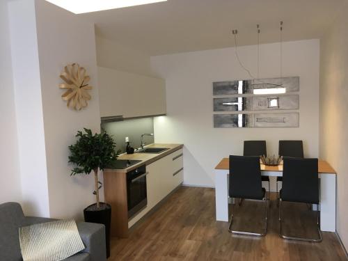 a kitchen and dining room with a table and chairs at Apartmán Jestřáb Janské Lázně in Janske Lazne