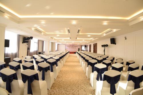 a room with a row of chairs in a hall at Phu Cuong Hotel Ca Mau in Cà Mau