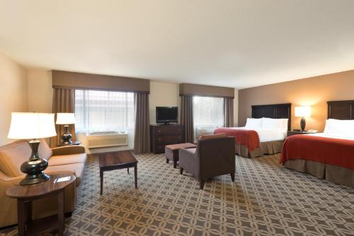 a hotel room with two beds and a couch at Holiday Inn Express Show Low by IHG in Show Low