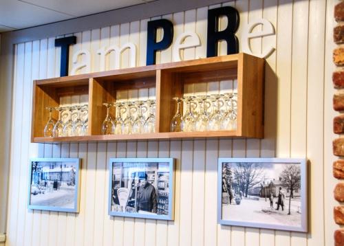 a store with wine glasses on a wall at Holiday Inn Tampere - Central Station by IHG in Tampere
