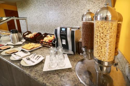 a kitchen counter with a table with food and a blender at Holiday Inn Tampico-Altamira by IHG in Tampico