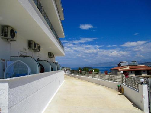 a balcony of a building with a view of the ocean at Hotel Mira Mare in Ksamil