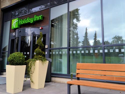 a bench sitting in front of a store front at Holiday Inn Tampere - Central Station by IHG in Tampere