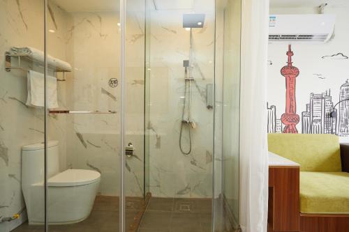 a bathroom with a shower with a toilet and a sink at Shanghai Meego Qingwen Hotel in Shanghai