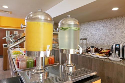 a kitchen with two large containers of juice at Holiday Inn Tampico-Altamira by IHG in Tampico