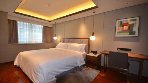 Ένα ή περισσότερα κρεβάτια σε δωμάτιο στο Holiday Inn Suites Xi'an High-Tech Zone by IHG