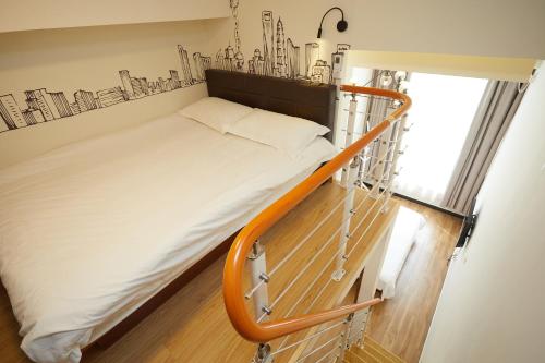 a bedroom with a bed with a metal rail at Shanghai Meego Qingwen Hotel in Shanghai