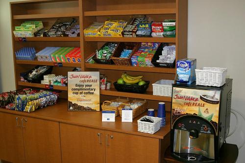 a counter in a store with snacks and a coffee machine at Candlewood Suites Macon by IHG in Macon