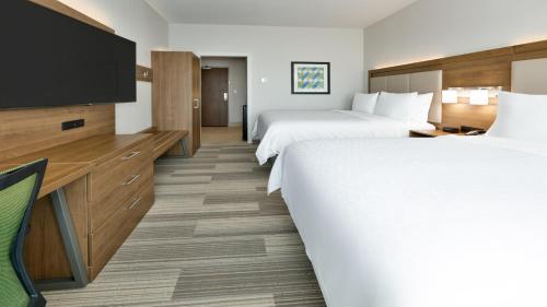 a hotel room with two beds and a flat screen tv at Holiday Inn Express Hotel & Suites Oklahoma City-West Yukon by IHG in Yukon
