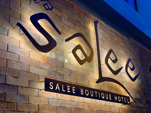 a sign on the side of a brick wall at Salee Boutique Hotel in Chiang Mai