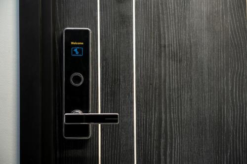 a close up of a door with a remote control at Salee Boutique Hotel in Chiang Mai