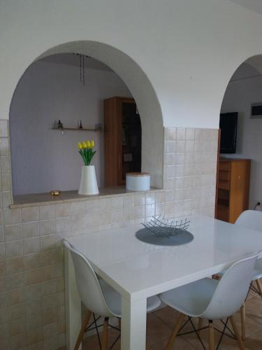 a kitchen with a white table and chairs at Apt Ingrid in Pula