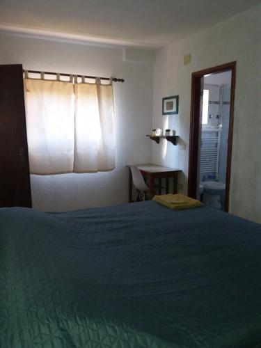 a bedroom with a bed and a table and a window at Apt Ingrid in Pula