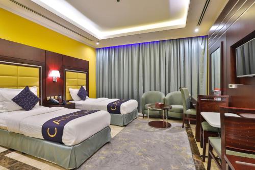 Ένα ή περισσότερα κρεβάτια σε δωμάτιο στο Telal Hotel Apartments