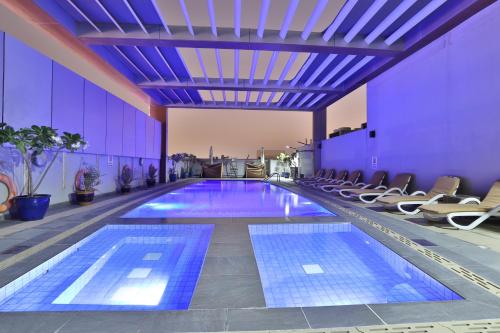 a swimming pool on the roof of a building at Telal Hotel Apartments in Dubai