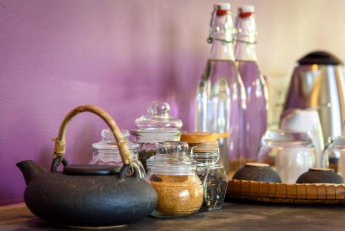 a table with many glass jars and bottles on it at Sala Baï Hotel & Restaurant School in Siem Reap