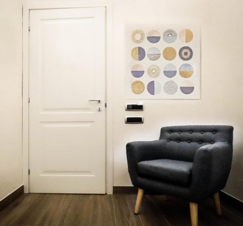 a black chair in front of a white door at My Maison 109 Guest House in Rome