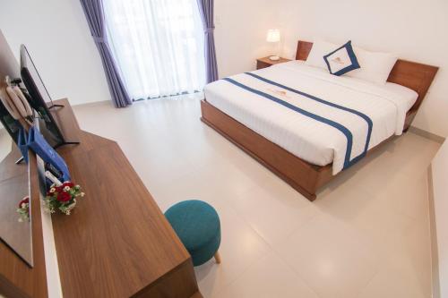Ένα ή περισσότερα κρεβάτια σε δωμάτιο στο Mermaid Seaside Hotel