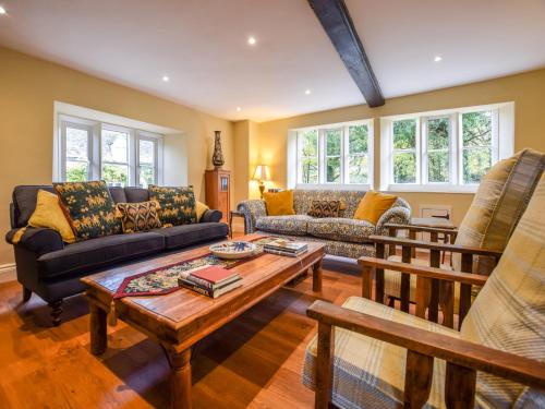 a living room with a couch and a coffee table at Archers in Winchcombe